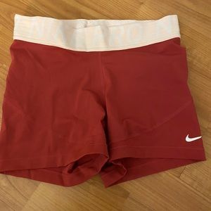 Pink and red Nike pro shorts